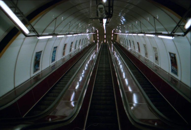 an escalator view of the inside of an underground station