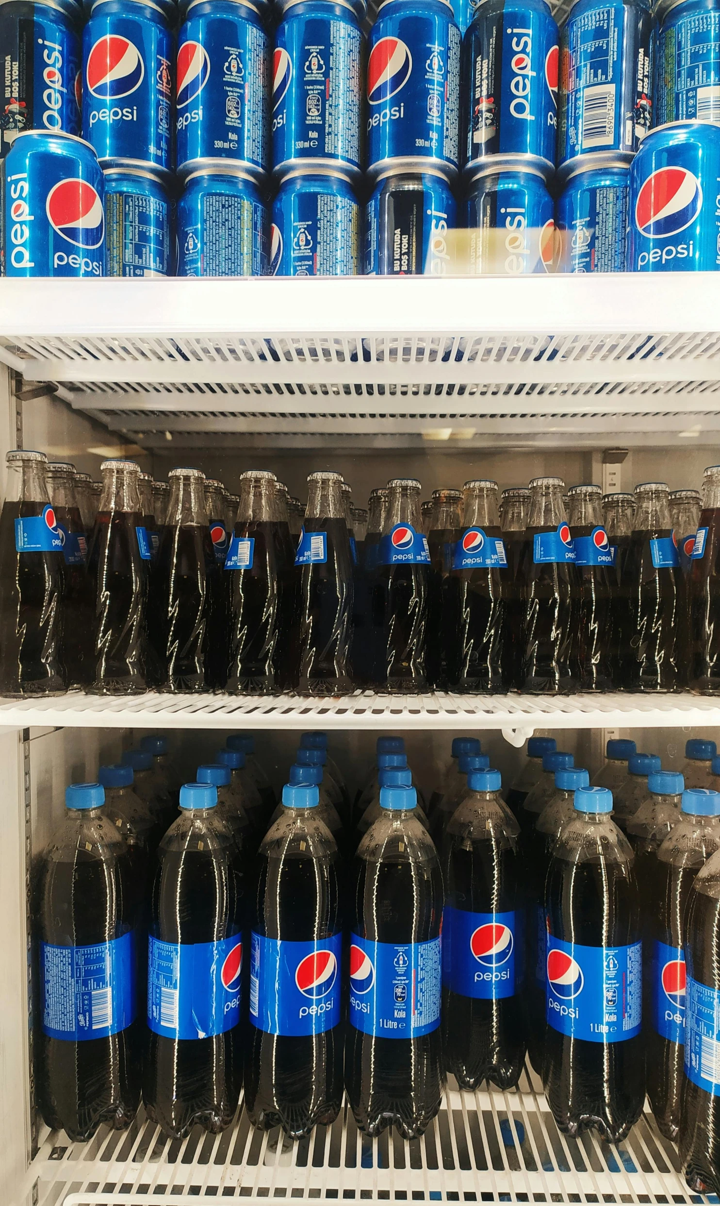 a refrigerator filled with lots of bottles of soda, pexels, hyperrealism, taken on iphone 14 pro, the store, pepsi, 1 6 x 1 6