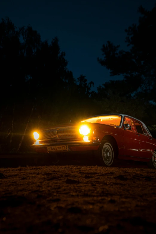 a car on the road in the dark with its headlights turned off