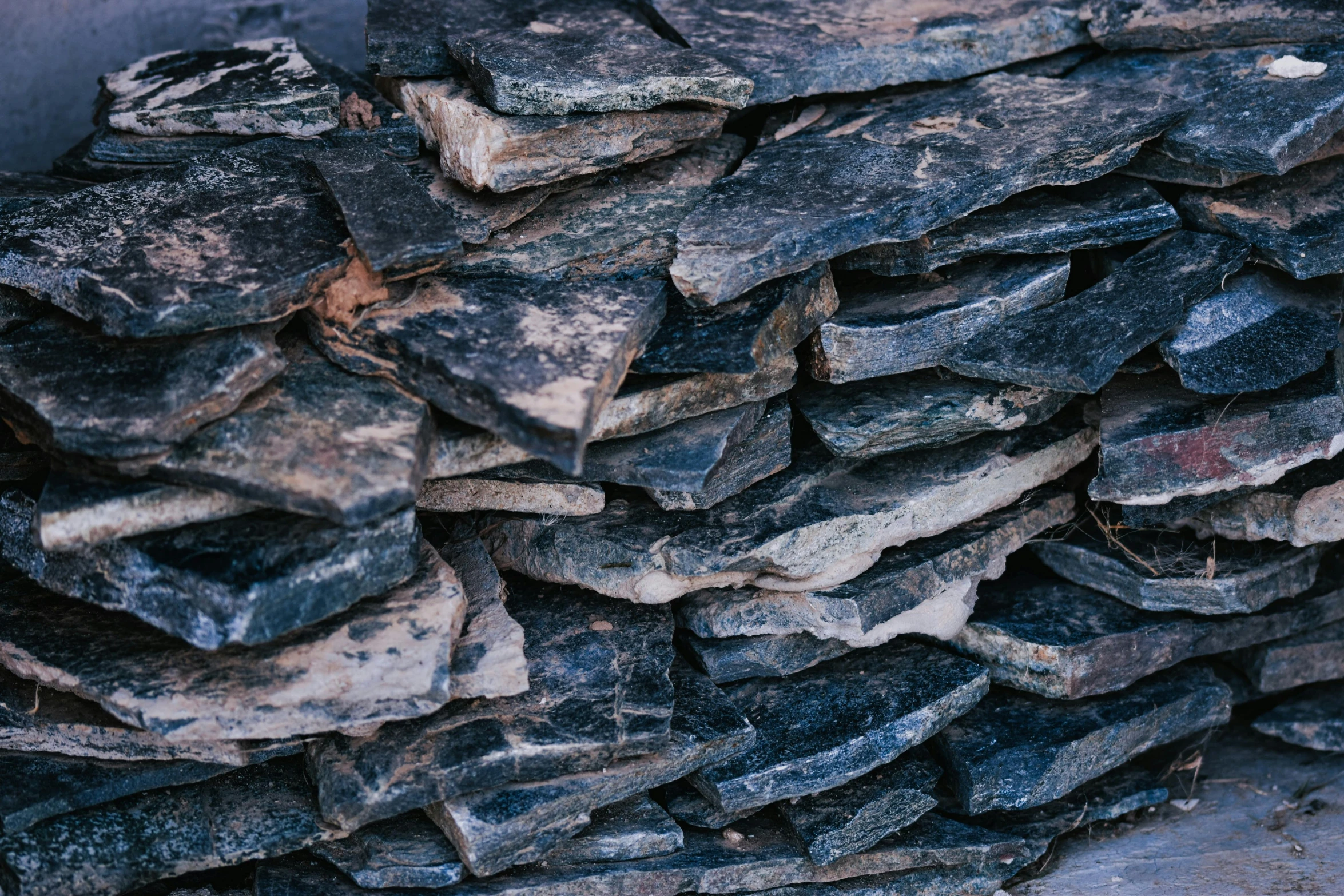 a pile of rocks stacked on top of each other, an album cover, unsplash, roofing tiles texture, background image, ((rocks)), bark