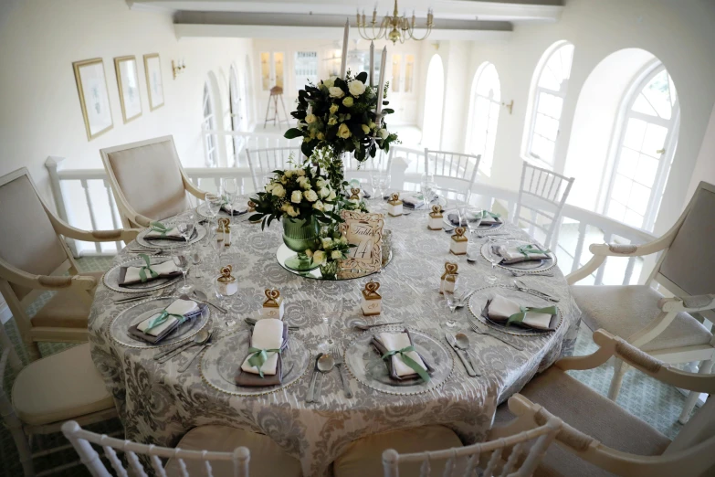 a white table set with four chairs for a wedding