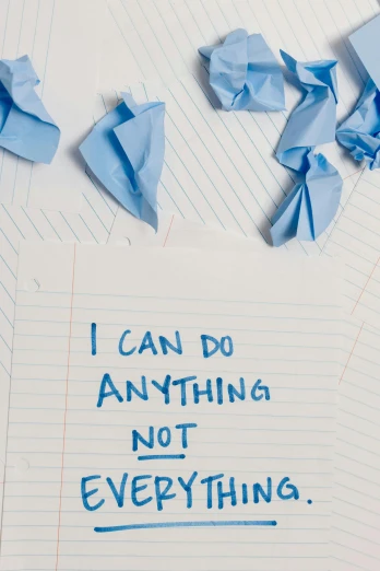 a notebook with the words i can do anything not everything written on it, antipodeans, scattered rubbish, blue torn fabric, forgiveness, gettyimages
