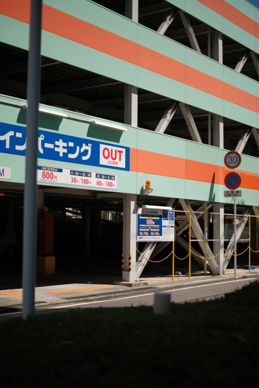 a building with orange and blue stripes and metal railing