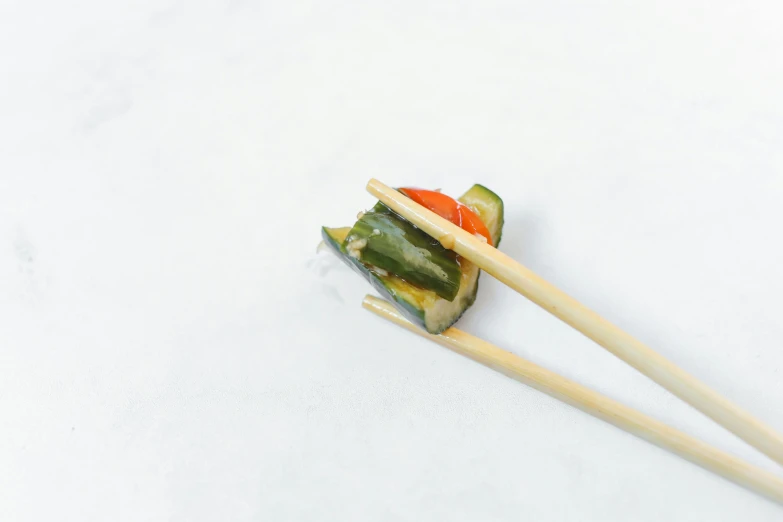 a piece of sushi with chopsticks sticking out of it, inspired by Maki Haku, unsplash, on white background, vegetable, 15081959 21121991 01012000 4k, battered