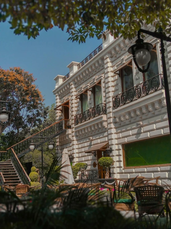 a house with stairs in front of it and many windows