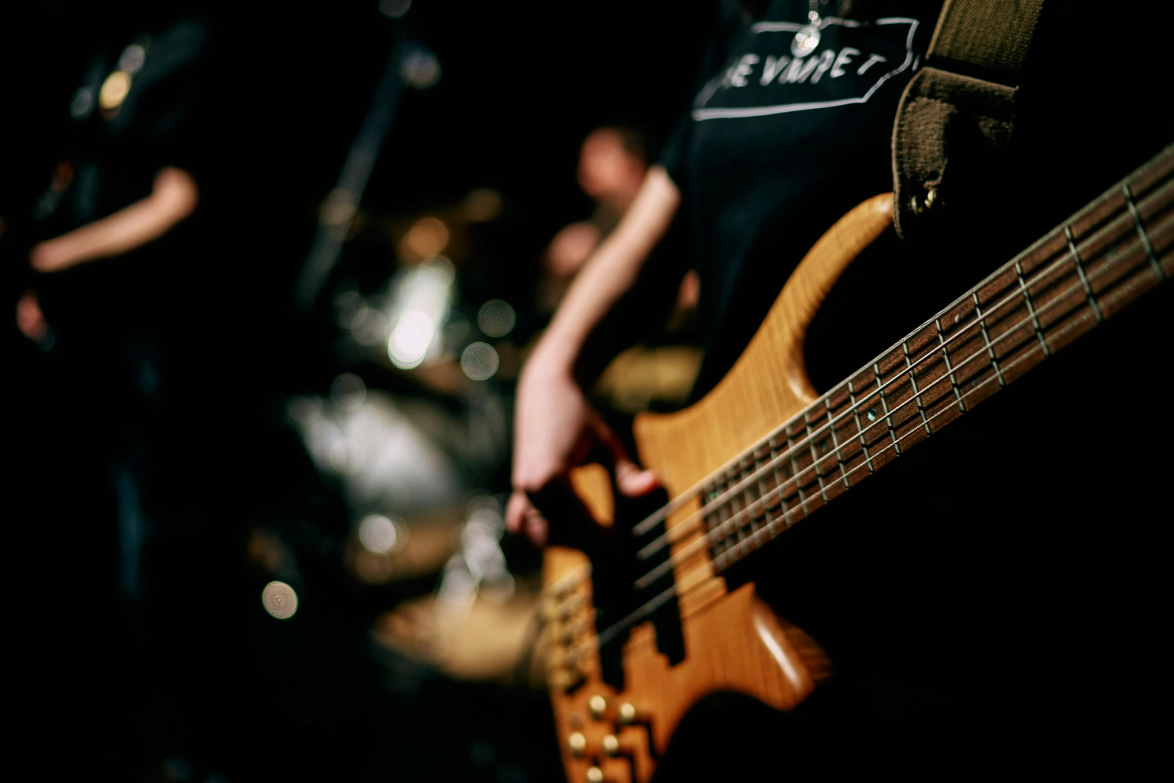 a close up of a person playing a bass guitar, profile image