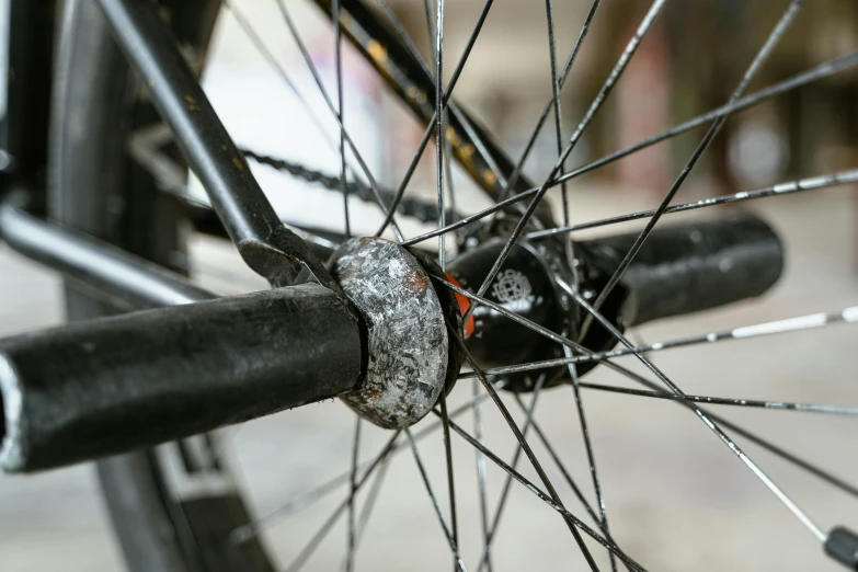 a close up of the spokes of a bicycle, by Joe Stefanelli, pexels contest winner, realism, moldy, drops around, surrounding the city, protective