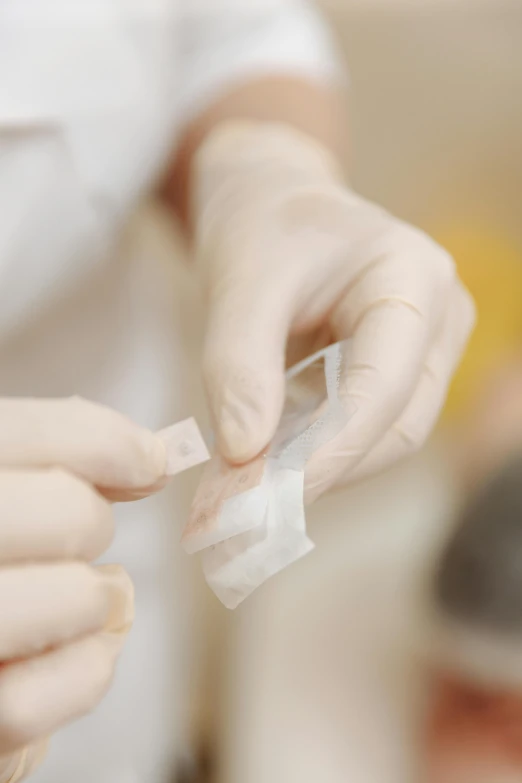 a close up of a person putting something in a container, bandages, made of lab tissue, profile image, aesthetics