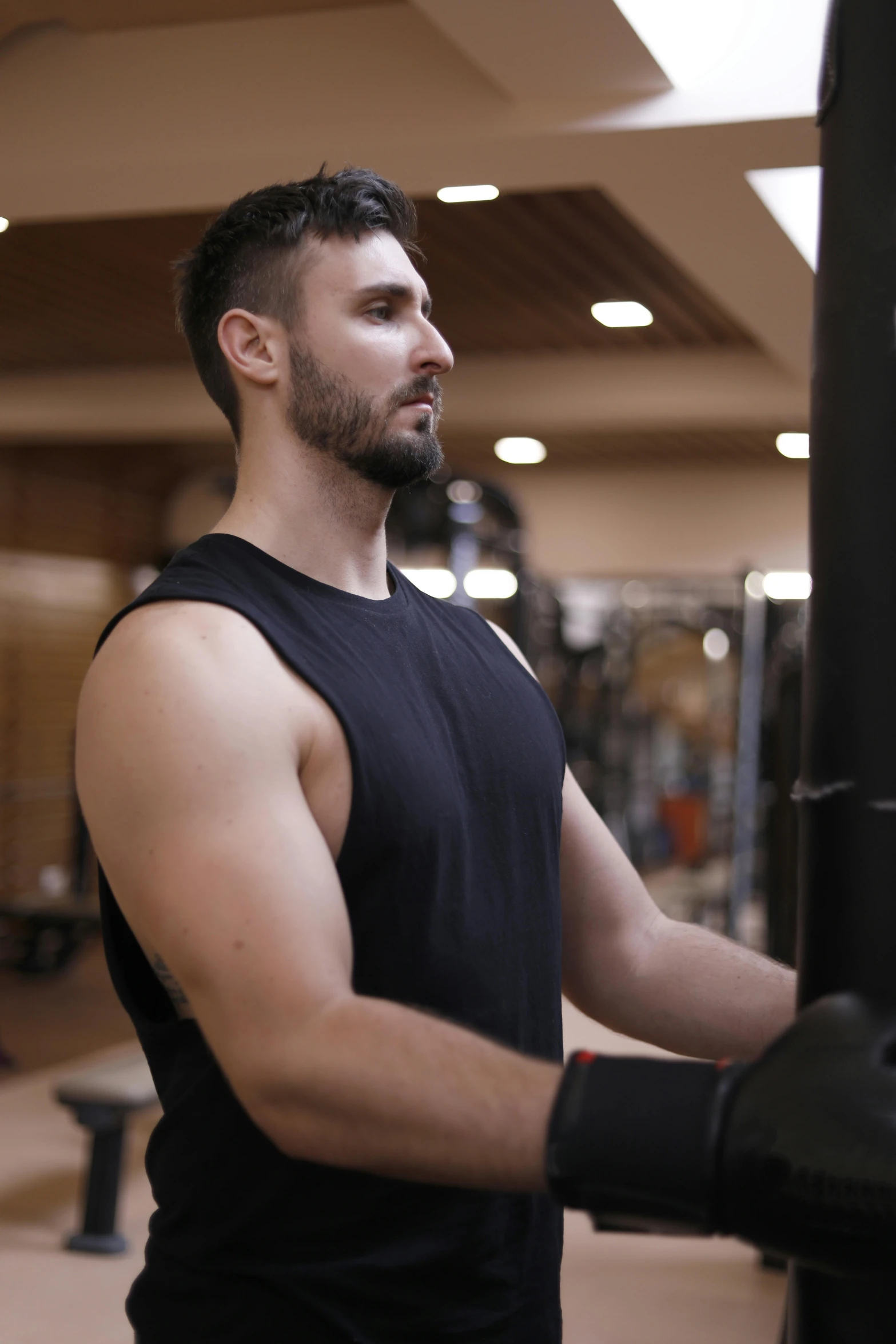 a man with muscular arms and a beard wearing boxing gloves