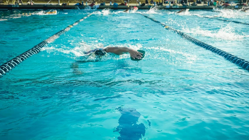 some swimmers in an open pool of water