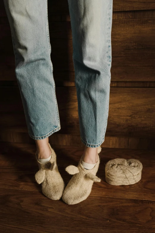 legs in slippers on the wooden floor with brown carpet