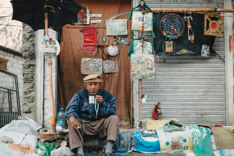 a man sitting on a bench in front of a store