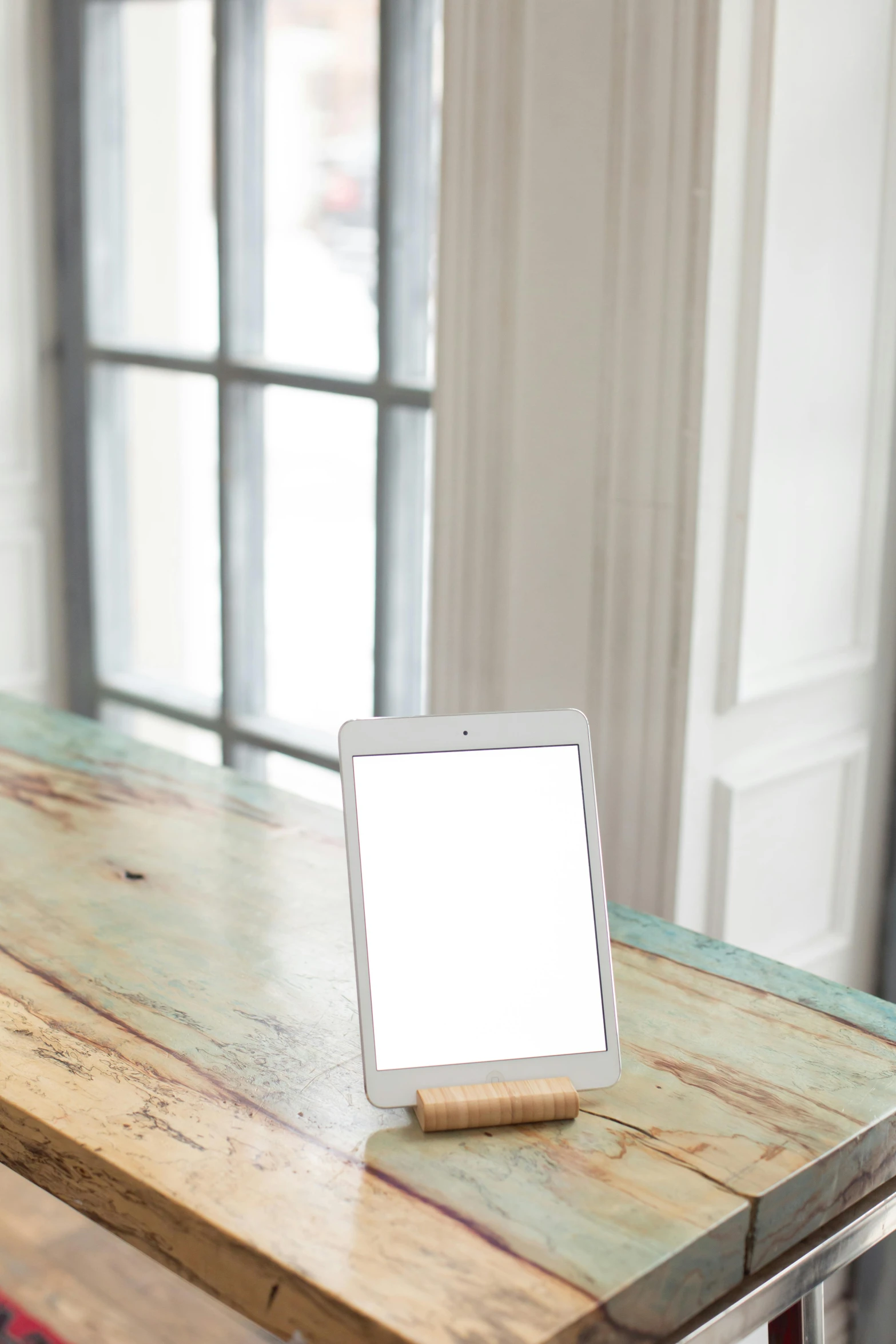 a tablet computer sitting on top of a wooden table, by Joseph Severn, modernism, light frame, medium-shot, square face, indoor light