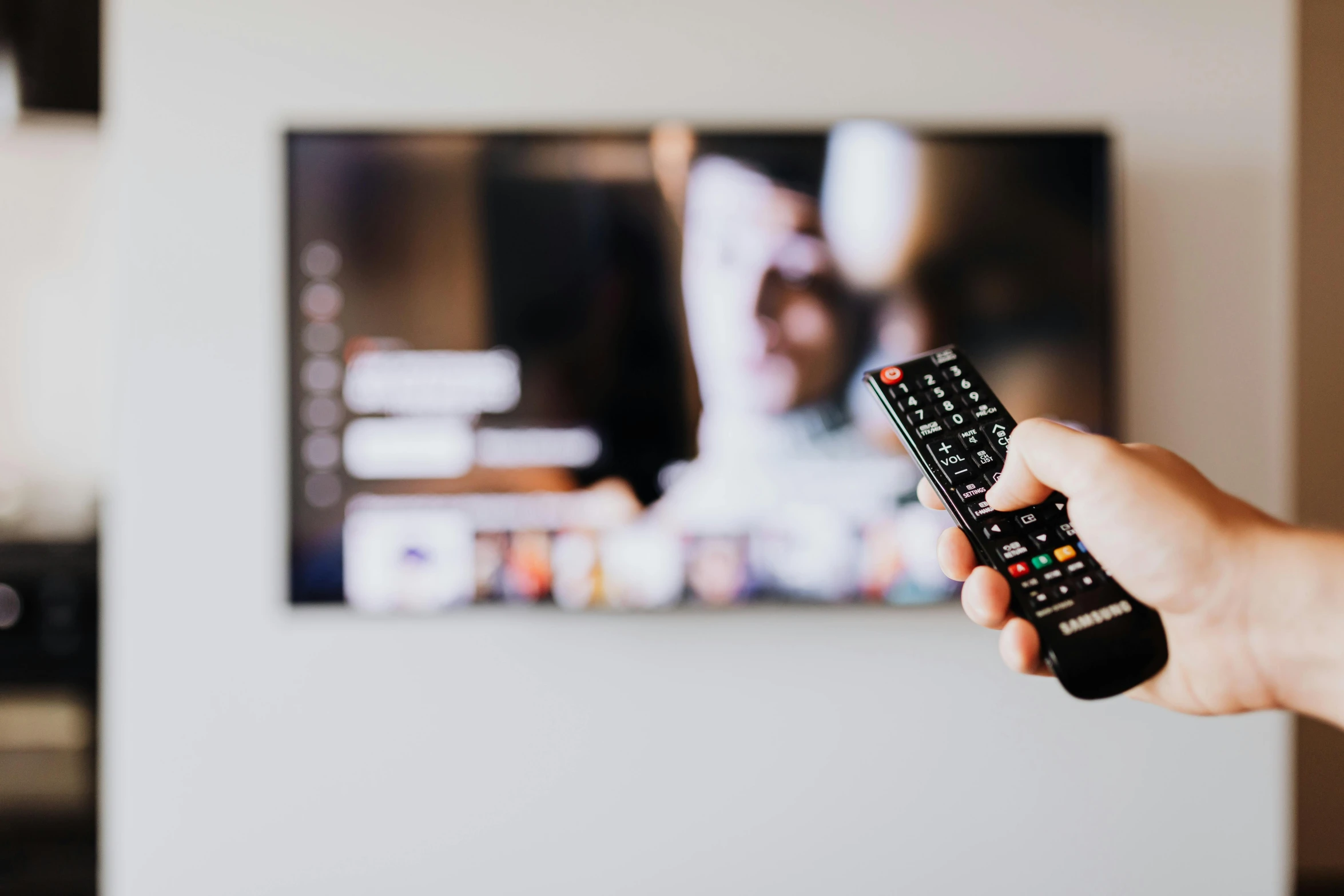 a person holding a remote control in front of a television, by Adam Marczyński, pexels, instagram post, 🦩🪐🐞👩🏻🦳, commercial banner, colour corrected