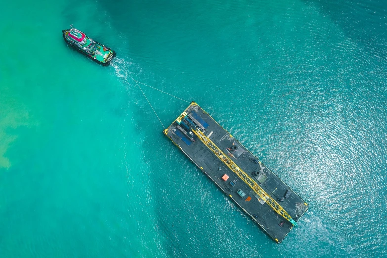 a couple of boats that are in the water, pexels contest winner, hurufiyya, oil rig, taking from above, full colour, high quality product image”