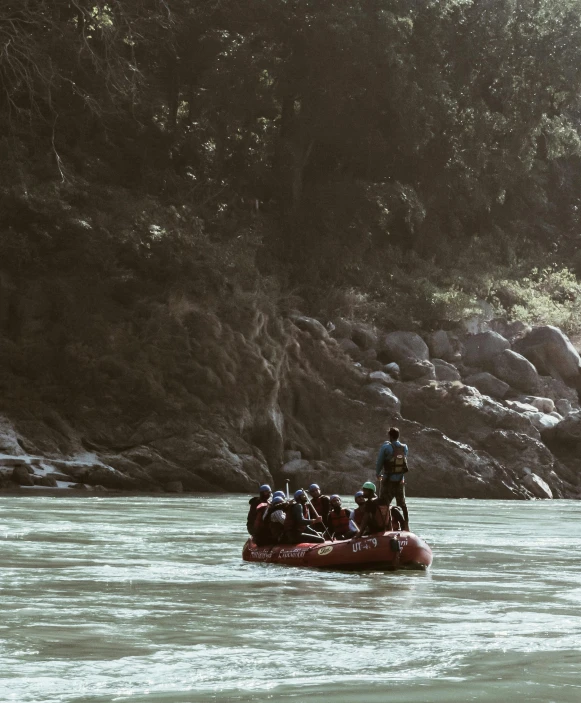 a group of people riding in a raft down a river, by Jessie Algie, pexels contest winner, sumatraism, instagram story, overlooking, still from a wes anderson movie, deep colour