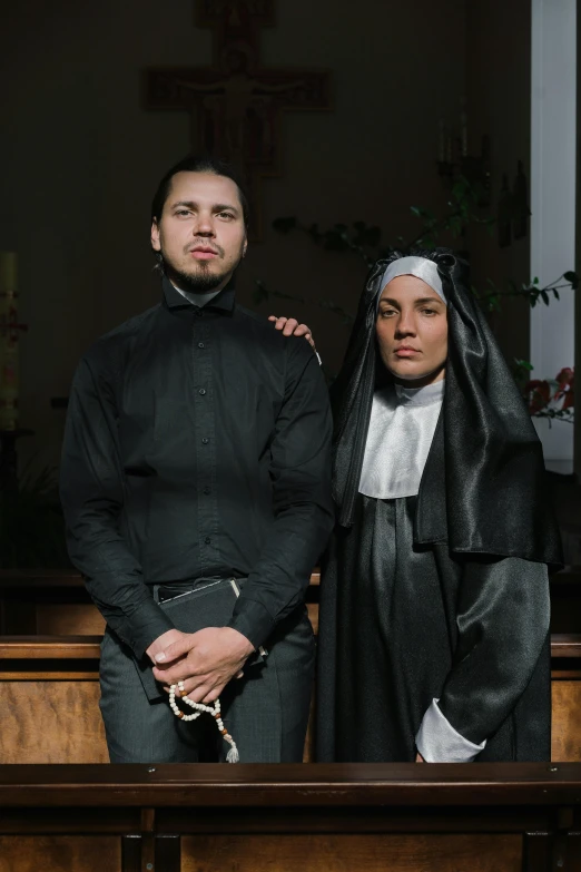 a couple of men standing next to each other, by Elsa Bleda, antipodeans, jayson tatum as mother mary, dressed in dark garment, ( ( theatrical ) ), genderless