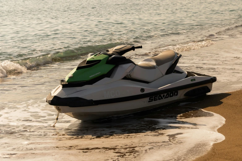 a jet ski sitting on top of a beach next to the ocean, dark green water, profile image, evening sunlight, green waters