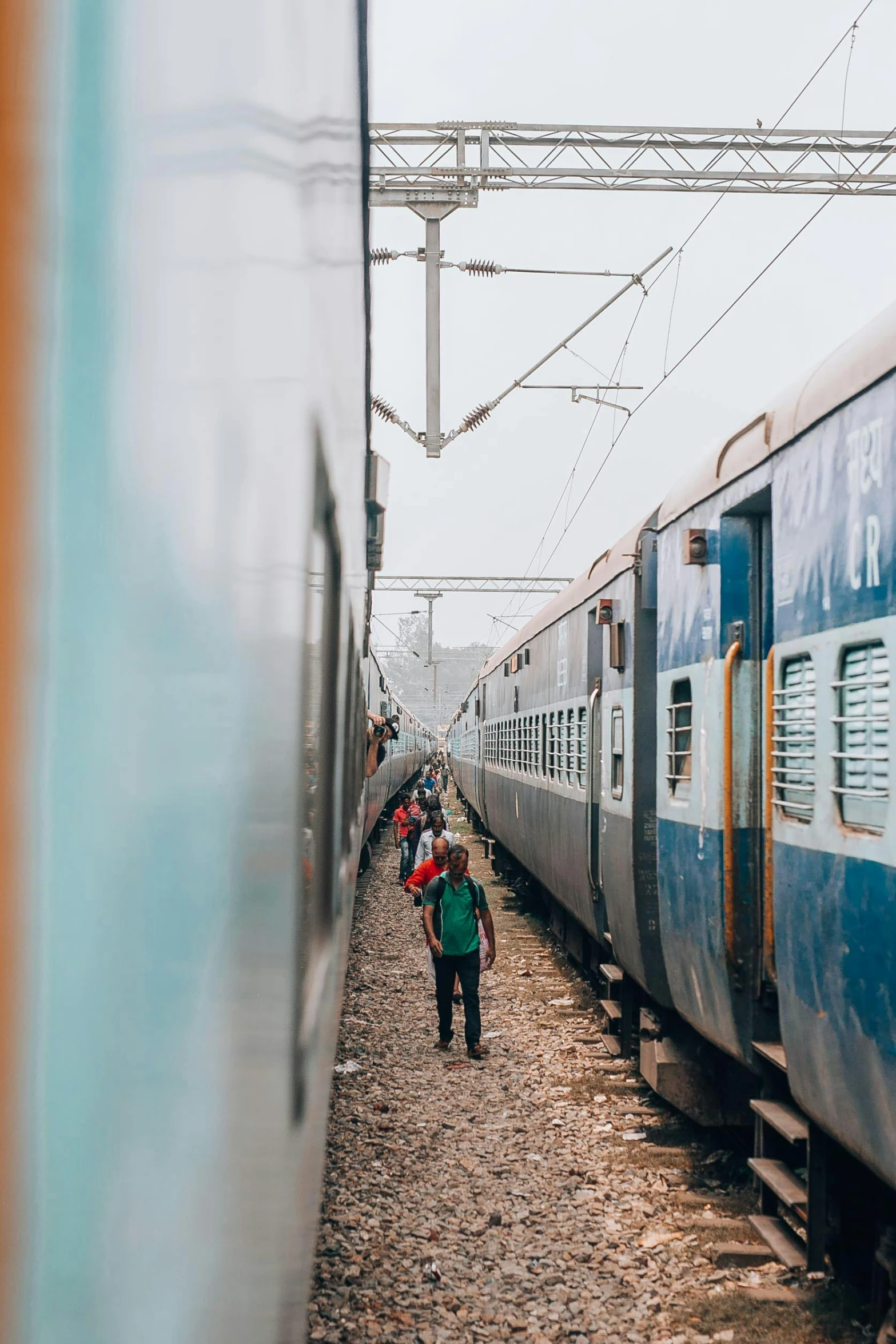 a group of people walking next to a train, pexels contest winner, happening, hindu aesthetic, sprawling, 🚿🗝📝, thumbnail