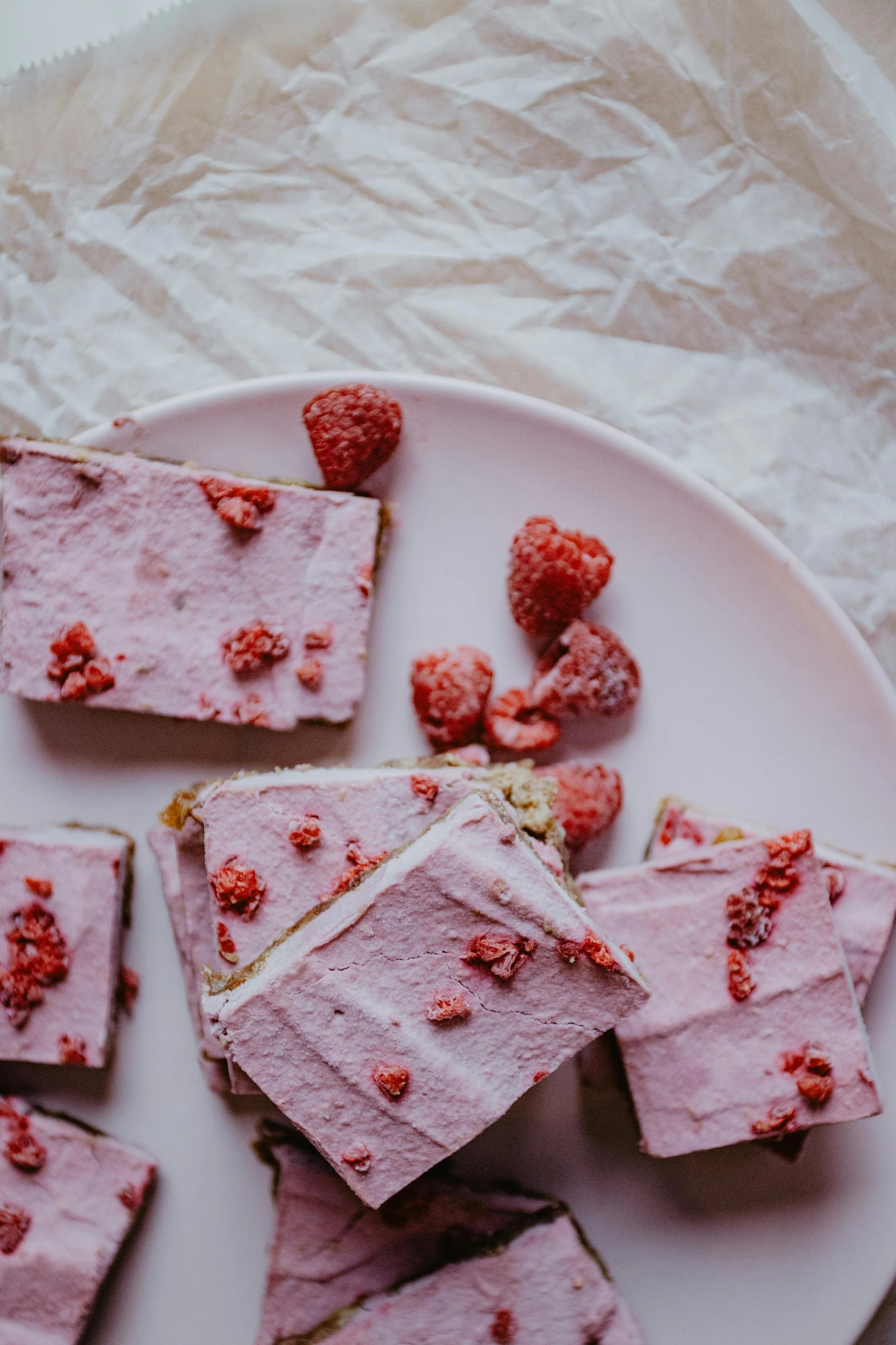 a white plate topped with slices of raspberry cheesecake, unsplash, romanticism, dragon fruits, frosted, rectangle, faded pink