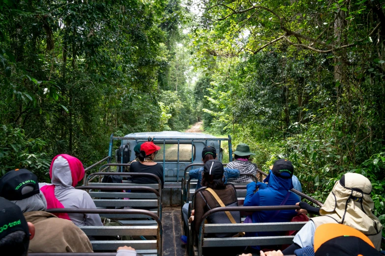 a group of people riding in the back of a truck, sumatraism, avatar image