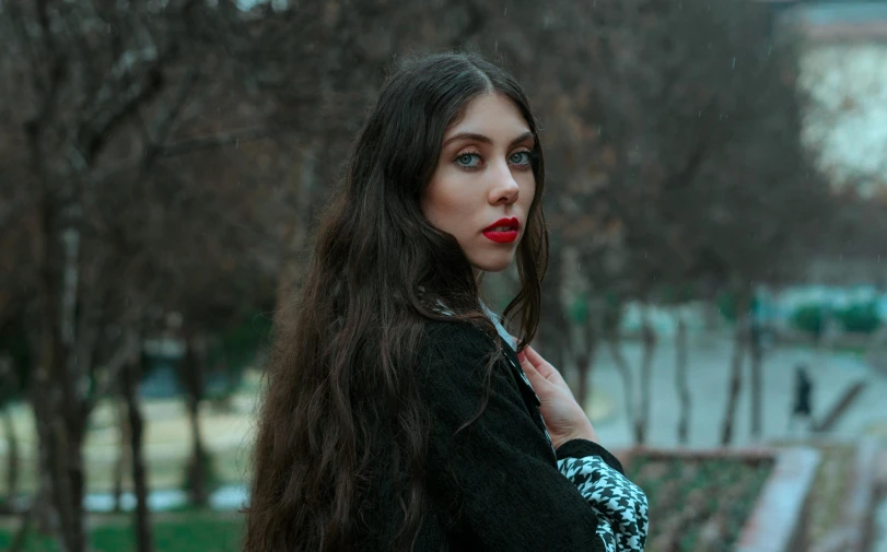 a woman with long brown hair holding an umbrella, inspired by Elsa Bleda, pexels contest winner, serious look, vampire girl, wearing a black sweater, anna nikonova aka newmilky