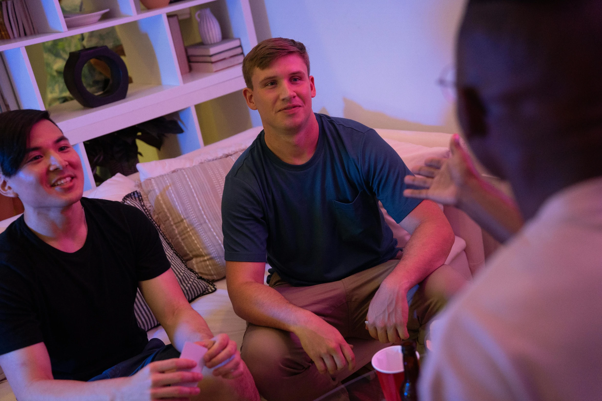 a group of men sitting on top of a couch, profile image, white male, low lighting, college