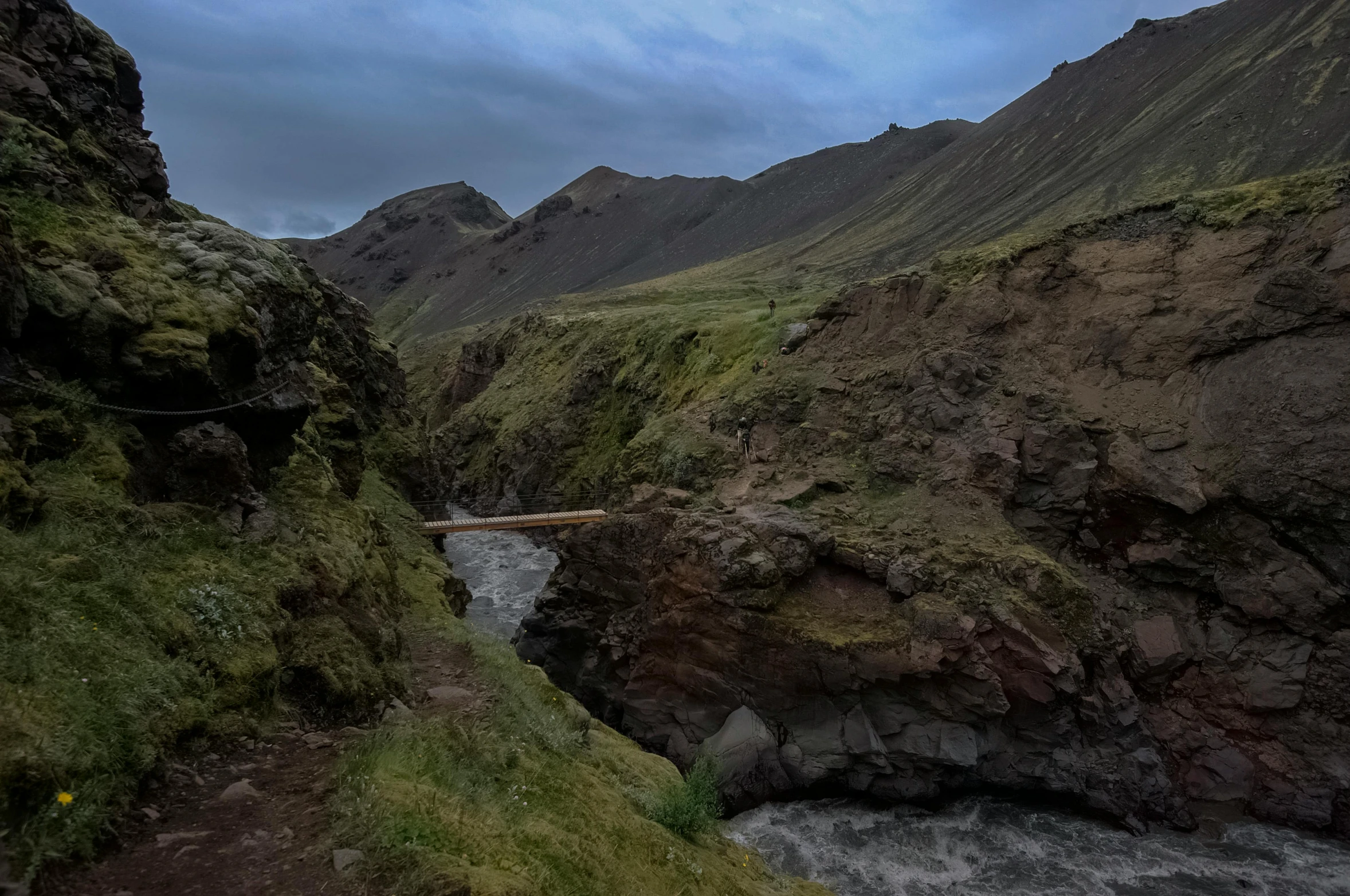 a landscape of mountains and rocks, with a creek