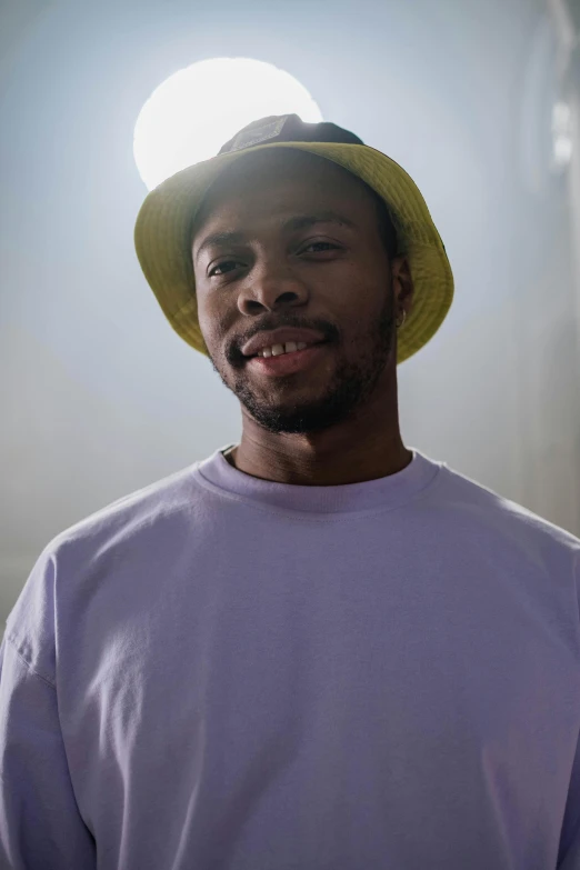 man wearing purple and yellow hat with sun light