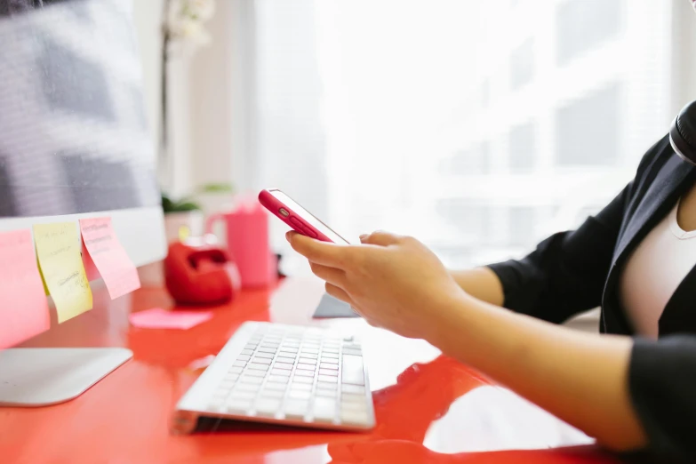 a woman sitting at a desk using a cell phone, pexels, sitting on a red button, in front of the internet, avatar image, close-up photo