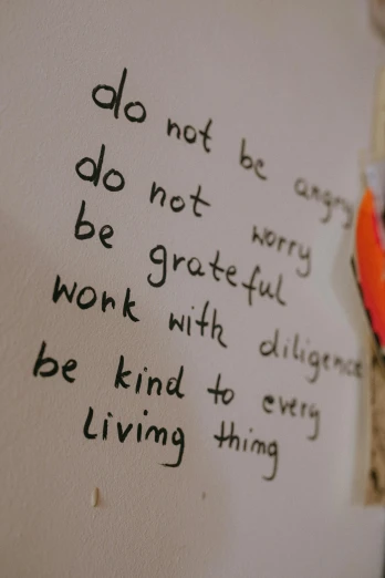 a close up of a piece of paper with writing on it, by Arabella Rankin, trending on pexels, on the walls, kindness, do