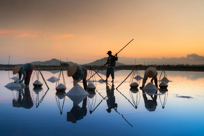 a group of people standing on top of a body of water, inspired by Steve McCurry, unsplash contest winner, process art, fishing, rice, mirror world, maintenance photo