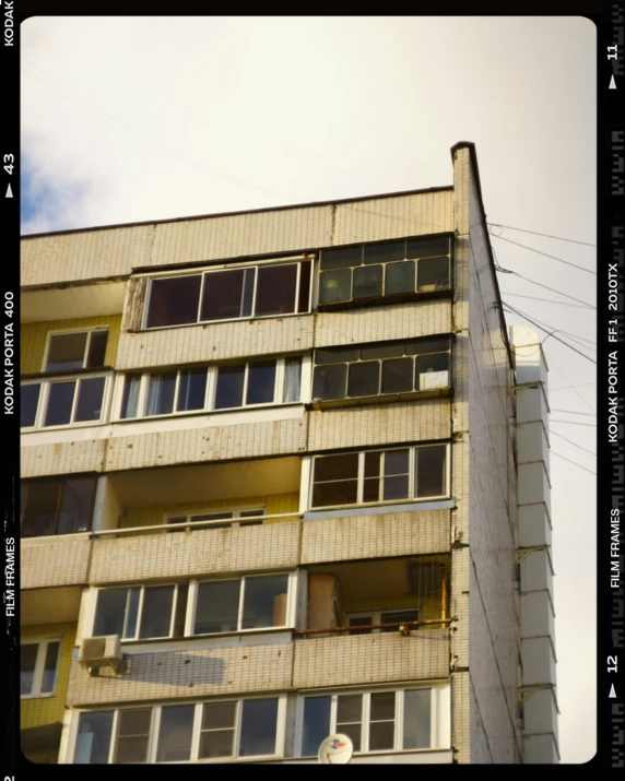 a very tall building with lots of windows, an album cover, inspired by Elsa Bleda, unsplash, brutalism, soviet town, 2022 photograph, polariod, rostov