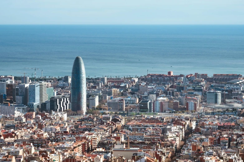 a view of a city with the ocean in the background, inspired by Tomàs Barceló, pexels contest winner, daniel libeskind, exterior shot, fc barcelona, thumbnail