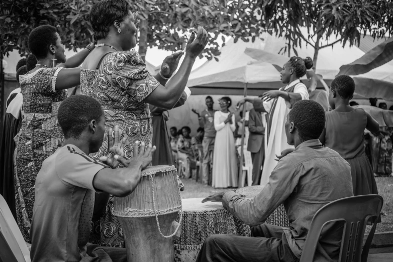 a black and white photo of a group of people, by Ingrida Kadaka, visual art, music being played, wedding, nostalgic 8k, audience