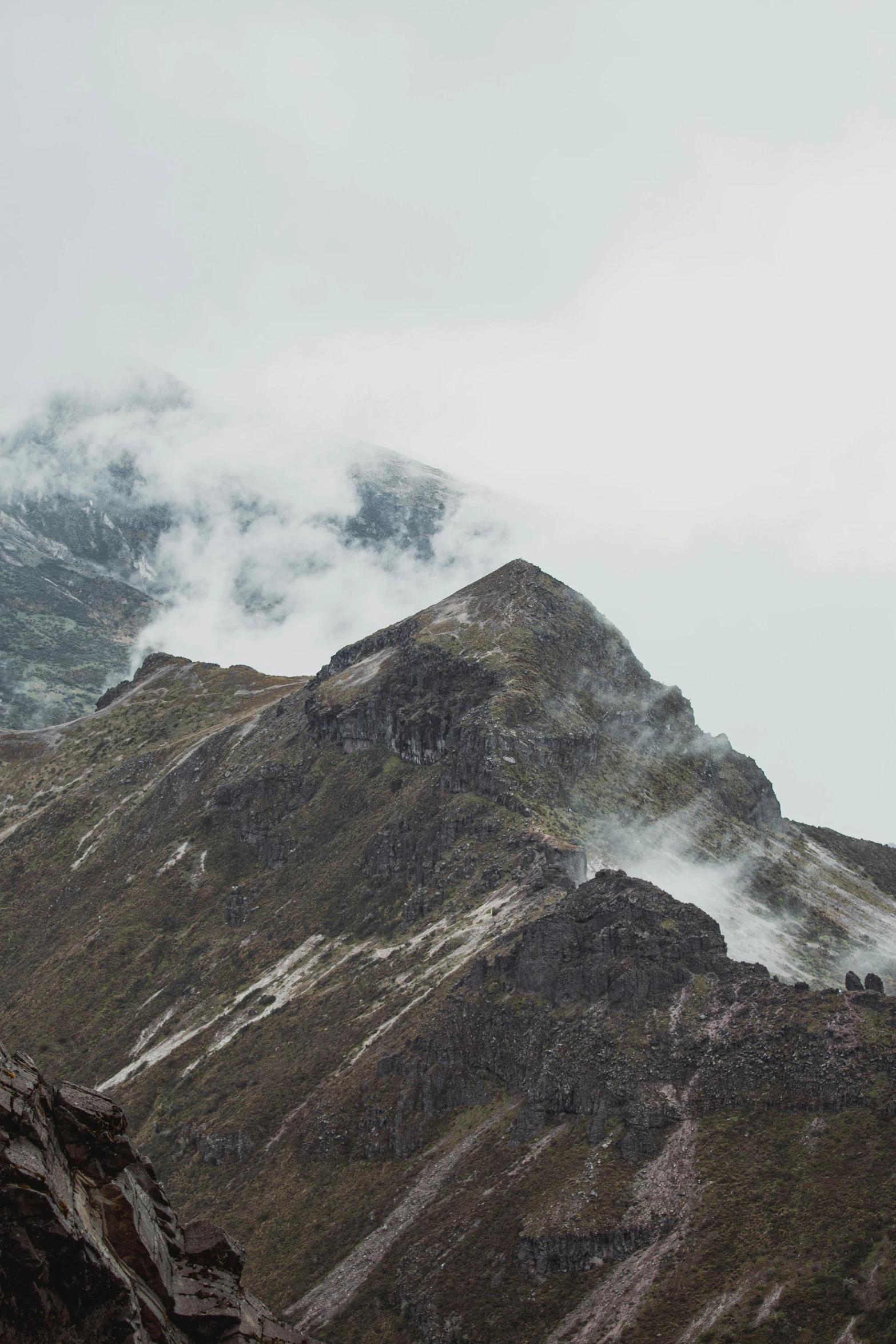 a mountain that has some clouds in the sky