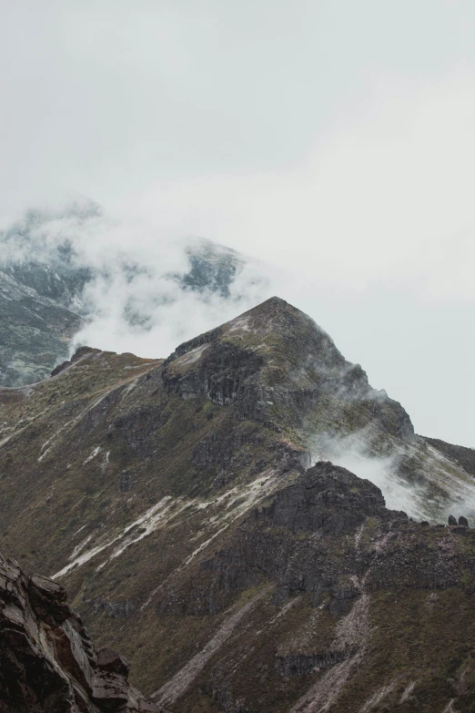 a mountain that has some clouds in the sky