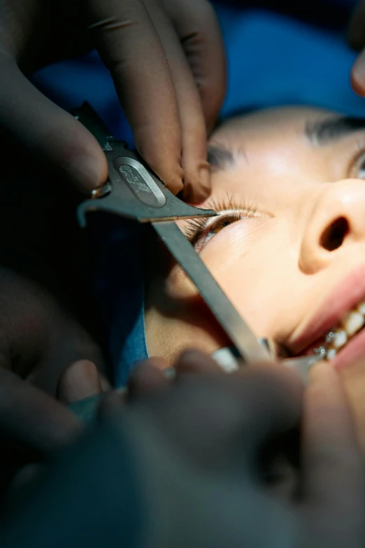 a close up of a person with a pair of scissors, reddit, hurufiyya, mirror eye implants, anaesthetic, female, pleasing face
