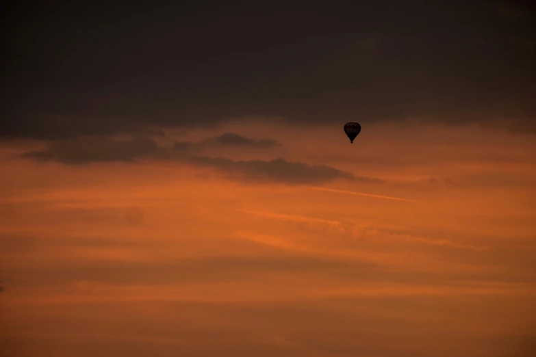 a  air balloon is flying in a cloudy sky