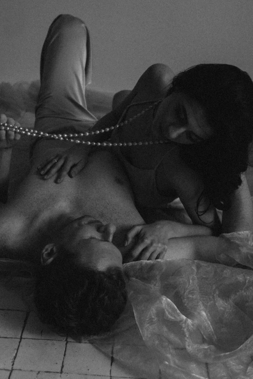 a man laying on top of a woman on a bed, a black and white photo, by Alexis Grimou, pearls and chains, charli bowater and artgeem, alessio albi, promo image