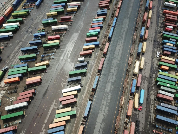 a train yard filled with lots of colorful train cars, unsplash, photorealism, shipping docks, alessio albi, 2000s photo, aerial photography