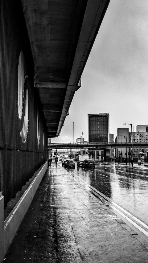 a black and white image of a wet road