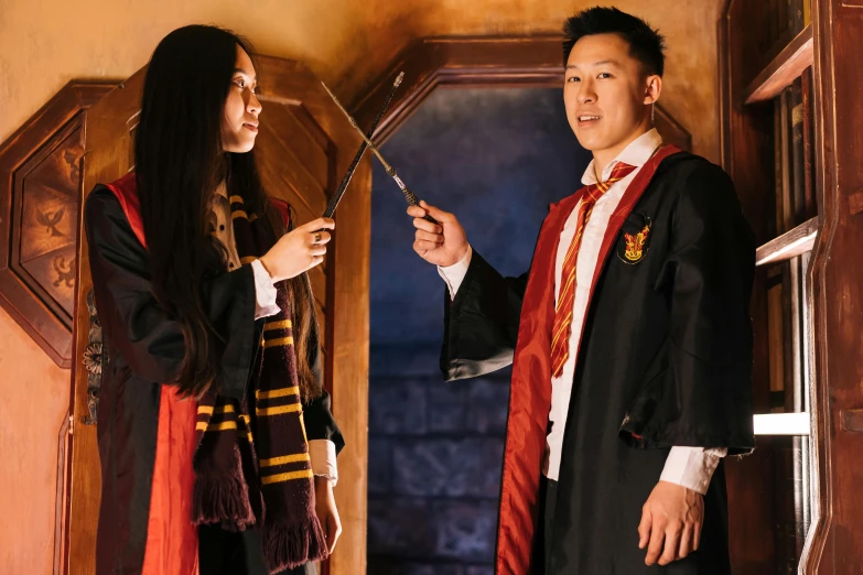 a couple of people standing next to each other, by Fuller Potter, pexels contest winner, hurufiyya, wizard themed, chinese, press shot, indoor scene