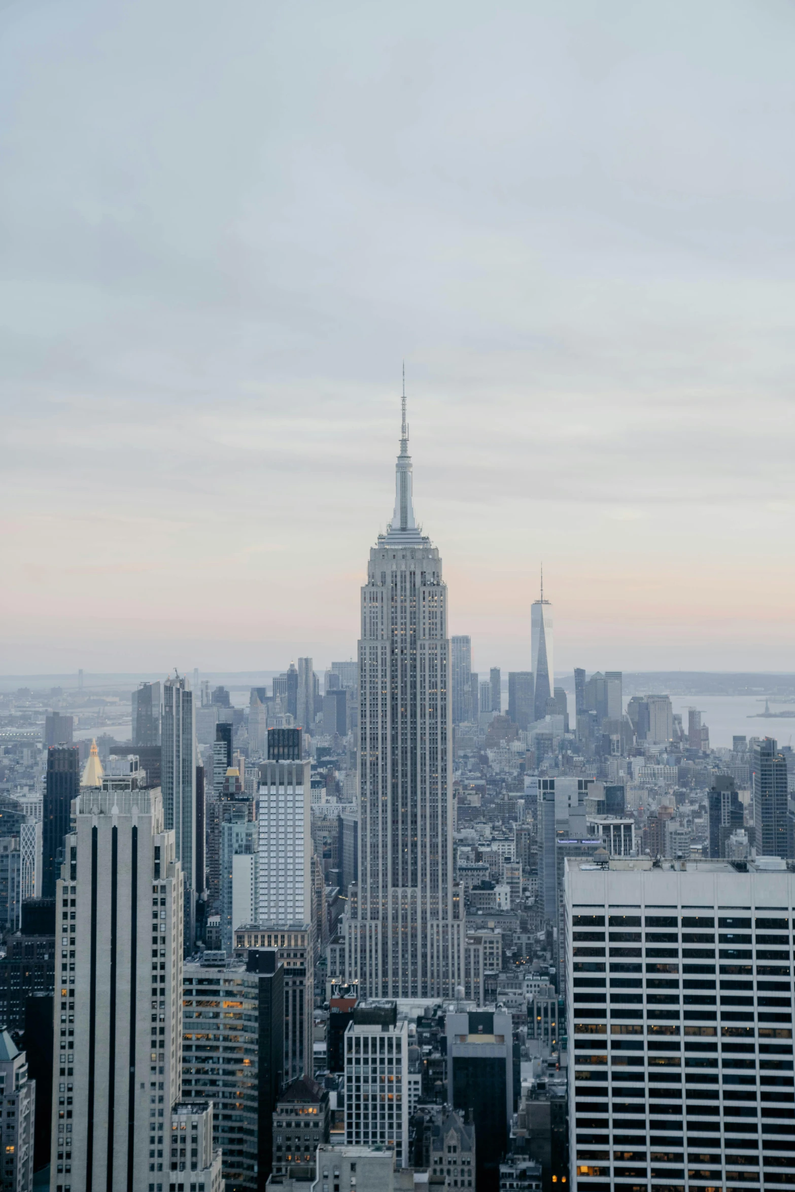 a view of a city from the top of a building, inspired by Andreas Gursky, trending on unsplash, hudson river school, empire state building, view(full body + zoomed out), late afternoon, white buildings
