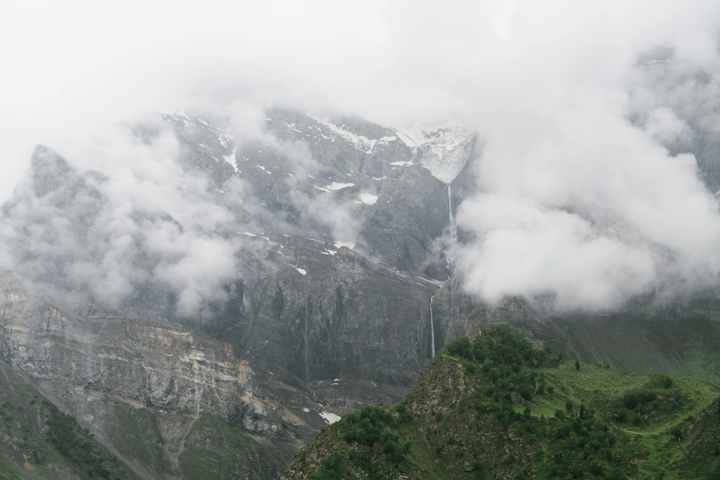 a mountain covered in lots of cloud and snow