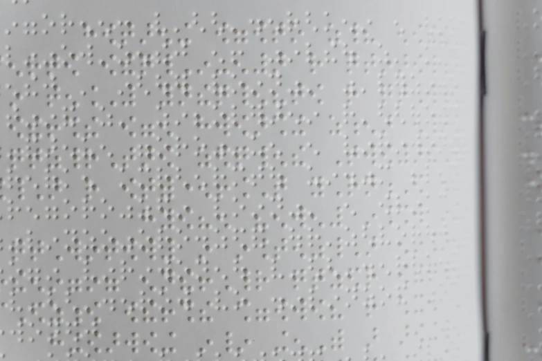 the back of a white box is textured with small dots