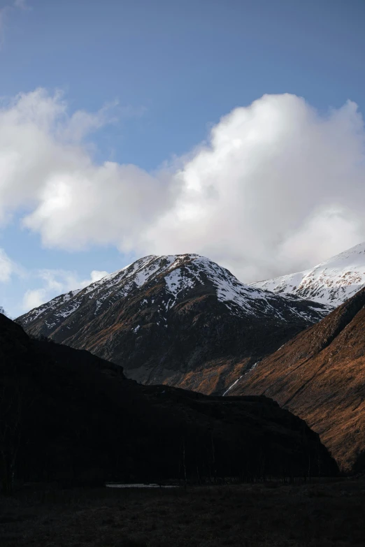 mountains that have been covered in snow and clouds