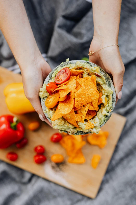 a person holding a tortilla in their hands, a colorized photo, by Nicolette Macnamara, trending on pexels, bowl filled with food, slate, light green, picnic