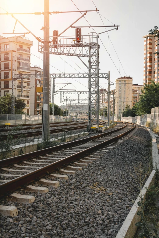 a train traveling down train tracks next to tall buildings, unsplash, in spain, large scale photo, panoramic, fan favorite