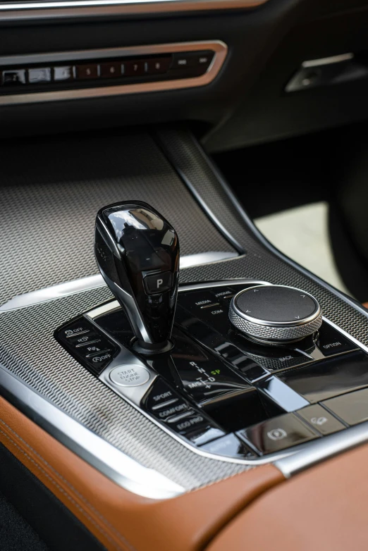 a close up of a gear stick in a car, inspired by Peter de Sève, gloss finish, bmw, rtx engine, model